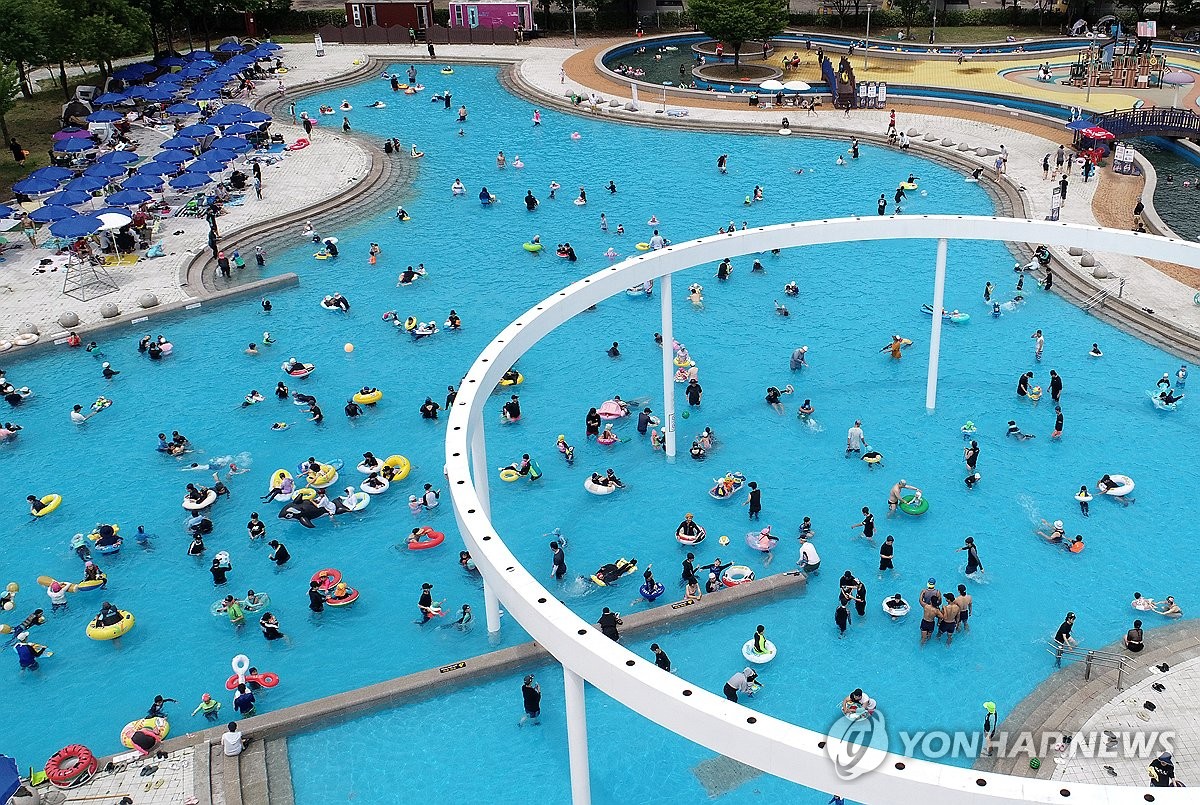 Swimming at outdoor pool amid sweltering heat