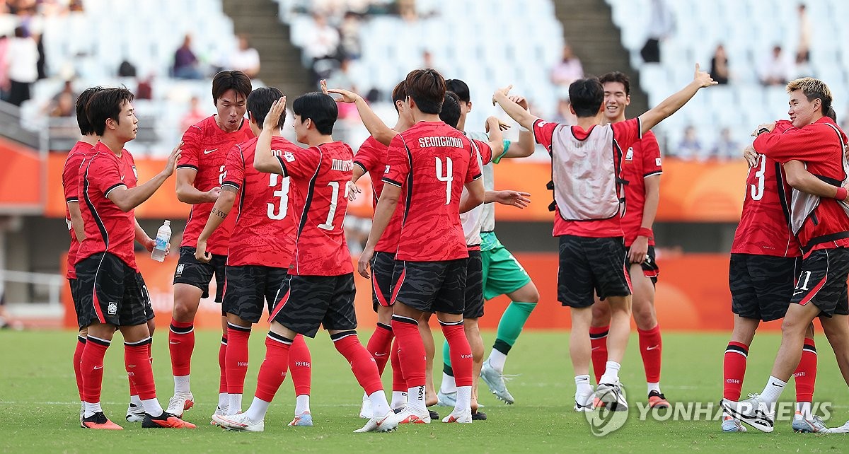 South Korean players celebrate after beating China 2-1 in the teams' semifinal match in men's football at the Aichi-Nagoya Asian Games at Nagai Stadium in Osaka, central Japan, on Sept. 30, 2026. South Korea won the match 2-1. (Yonhap) (END)