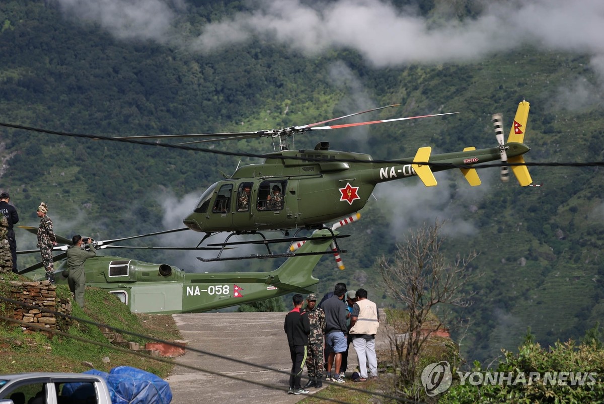 A Nepalese military helicopter carrying members of a South Korean government rapid response team takes off in the town of Dhunche, Nepal's Rasuwa district, on Sept. 1, 2026, as they search the flood-hit area as part of efforts to find nine South Koreans missing in massive floods in the country. (Yonhap) (END)