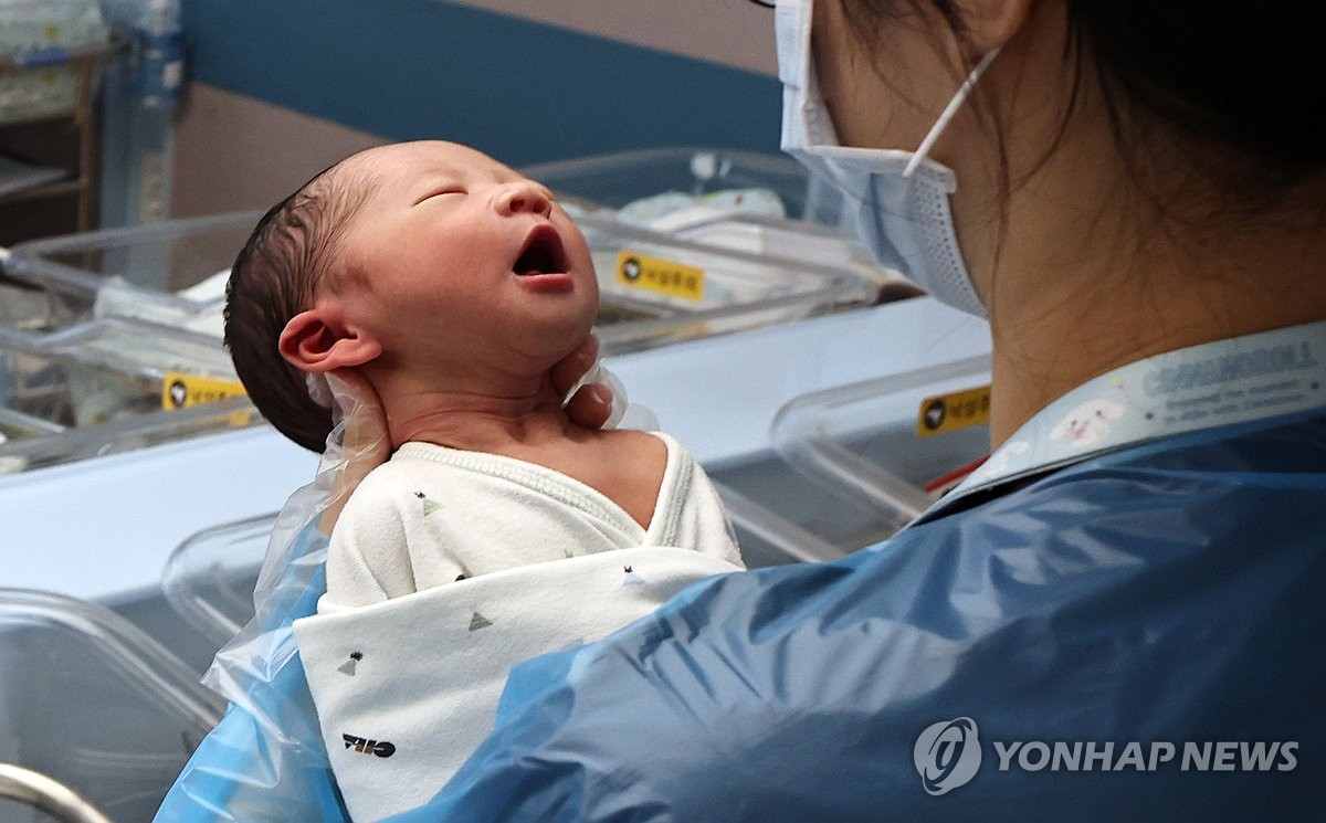 A nurse cares for a newborn at a hospital in Goyang, just west of Seoul, on Dec. 26, 2025. (Yonhap)