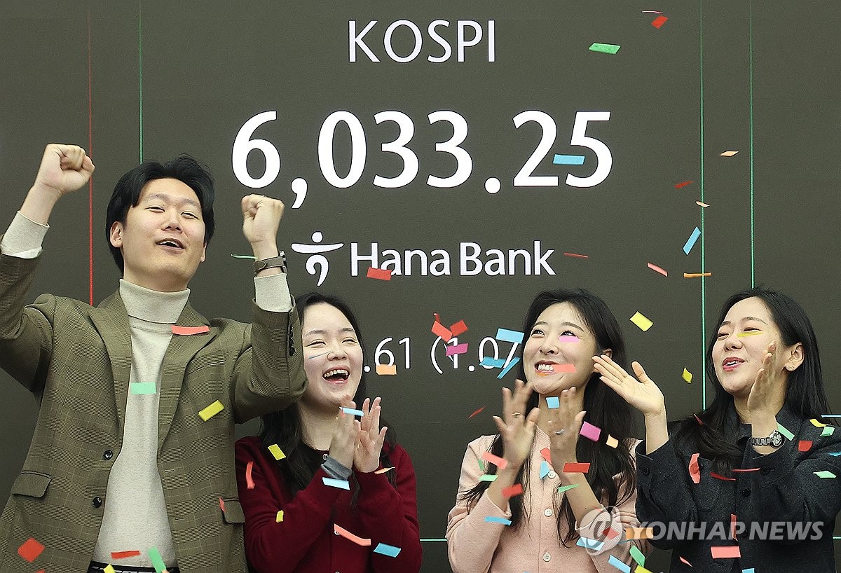 Workers celebrate in the dealing room of Hana Bank in central Seoul as the benchmark Korea Composite Stock Price Index (KOSPI) briefly breached the 6,000-point mark at the opening bell on Feb. 25, 2026. (Yonhap)