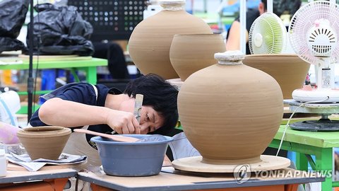 A potter is at work shaping a pot during the ceramic craft segment of the 61st National Skills Competition at the Songdo Convensia convention center in Incheon, west of Seoul, on Aug. 24, 2026. (Yonhap) (END)