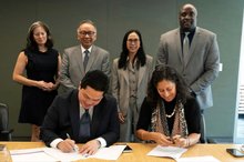 Indonesia's Youth and Sports Minister Erick Thohir (left) signs an MoU with a representative from New York University to explore collaboration on sports science and development. 