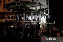 Firefighters tackle a blaze in a damaged building near the Al-Ahli (Baptist) Hospital following an Israeli strike in eastern Gaza City