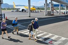 Several airline passengers walk upon arrival at Komodo Airport