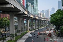 Vehicles pass along Jalan Rasuna Said in Kuningan, Jakarta
