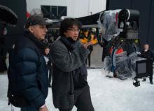Director Bong Joon-ho (R) is seen working on the set of his upcoming film in this photo provided by Warner Bros. Korea on March 14, 2024. (PHOTO NOT FOR SALE) (Yonhap)
