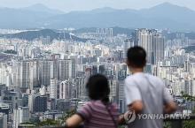 People look at skyscrapers in Seoul from Namsan Observatory in Seoul on July 15, 2024. (Yonhap)