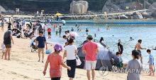 People enjoy their time at a beach in Incheon, west of Seoul, on Sept. 18, 2024. (Yonhap)