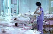 A worker holds a baby at a public postnatal care center in Seoul in this file photo taken Dec. 26, 2023. (Yonhap)