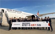 This photo taken on Dec. 19, 2024, and provided by Air Premia shows the company's CEO Kim Jae-hyun (7th from left) and employees posing for a photo during an event to receive its sixth chartered plane at Incheon International Airport in Incheon, just west of Seoul. (PHOTO NOT FOR SALE) (Yonhap)