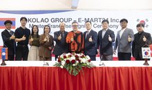 Officials from Emart24 and Kolao Group pose for a photo after signing a master franchise agreement at Kolao's headquarters in Vientiane, Laos, on Sept. 25, 2025, in this photo provided by Emart24. The deal marks the South Korean convenience store chain's entry into the Southeast Asian country. (PHOTO NOT FOR SALE) (Yonhap)