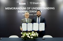 This photo, taken Oct. 24, 2025, and provided by Hyundai Rotem Co., shows the company's Executive Vice President Lee Jeong-yeob (L), head of the Defense Solution Business Division, and Mike Hanlin, Senior Director of International Strategy & Business Development at Shield AI, posing after signing a memorandum of understanding (MOU) on a partnership for artificial intelligence (AI)-based defense technologies during the 2025 Seoul International Aerospace & Defense Exhibition (ADEX) in Goyang, just northwest o