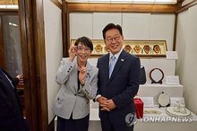 President Lee Jae Myung (R) wears glasses gifted by Japanese Prime Minister Sanae Takaichi, who is wearing Lee's glasses, as they pose for a photo at a hotel in Andong, about 190 kilometers southeast of Seoul, following their summit meeting on May 19, 2026, in this photo provided by the presidential office. (PHOTO NOT FOR SALE) (Yonhap)