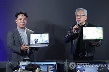 Nvidia Corp. Chief Executive Officer (CEO) Jensen Huang (R) with NCSOFT CEO Kim Taek-jin at an internet cafe in Seoul on June 7, 2026. (Yonhap)