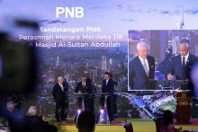 Malaysia's King Al-Sultan Abdullah Ri'ayatuddin Al-Mustafa Billah Shah (centre) graciously signed the inauguration plaque after delivering the opening address for the Menara Merdeka 118 tower on Wednesday.  Also present were the Chairman of PNB Group, Raja Tan Sri Arshad Raja Tun Uda (left), and the President and Chief Executive Officer of PNB Group, Ahmad Zulqarnain Onn (right).