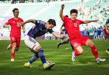 Japan's Shogo Taniguchi pushes Vietnam's defense during the match between the two countries at the Group D stage of the 2023 Asian Cup