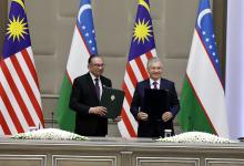 TASHKENT, May 17 -- Prime Minister Datuk Seri Anwar Ibrahim and President of Uzbekistan Shavkat Mirziyoyev exchanging documents after signing a joint statement at a meeting at the Kuksaroy Presidential Palace here on Friday.
