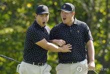 In this Canadian Press photo via Associated Press, Tom Kim (L) and Im Sung-jae of South Korea celebrate Kim's birdie putt on the seventh hole for the International Team during their fourball match at the Presidents Cup at Royal Montreal Golf Club in Montreal on Sept. 26, 2024. (Yonhap)