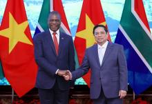 Prime Minister Pham Minh Chinh (right) shakes hand with Deputy President of South Africa Paul Mashatile prior to their talks in Hanoi on Thursday. (Photo: VNA)
