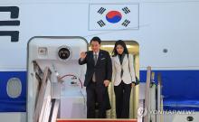 President Yoon Suk Yeol (L) and first lady Kim Keon Hee arrive at Seoul Airport in Seongnam, south of Seoul, on Nov. 26, 2023, after a visit to Britain and France, in this photo provided by his office. (PHOTO NOT FOR SALE) (Yonhap)