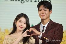 IU (L) and Park Bo-gum pose for photos during a press event for Netflix's upcoming Korean original "When Life Gives You Tangerines" in Seoul on March 5, 2025. (Yonhap)