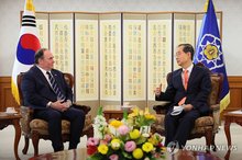 U.S. Navy John Phelan (L) meets then Acting President Han Duck-soo at the government complex in Seoul on April 30, 2025, in this photo released by Han's office. (PHOTO NOT FOR SALE) (Yonhap)