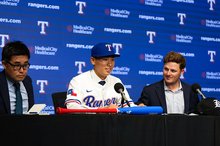 South Korean baseball player Kim Seong-jun (C) speaks at his introductory press conference after signing with the Texas Rangers at Globe Life Field in Arlington, Texas, on May 18, 2025, in this photo provided by the Rangers. (PHOTO NOT FOR SALE) (Yonhap)