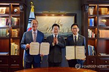 South Korean President Lee Jae Myung (C) poses for a photo with Larry Fink (L), chairman of the World Economic Forum and CEO of BlackRock, and South Korean Science and ICT Minister Bae Kyung-hoon after Bae and Fink signed a memorandum of understanding on an artificial intelligence partnership. (Pool photo) (Yonhap)