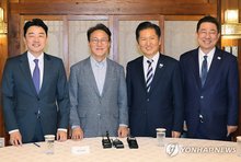 (From L to R) Presidential chief of staff Kang Hoon-sik, Prime Minister Kim Min-seok, Democratic Party (DP) leader Jung Chung-rae and DP floor leader Kim Byung-ki pose for a photo before attending a consultative meeting among the ruling party, the government and the presidential office at the prime minister's residence in Seoul Oct. 12, 2025. (Yonhap)