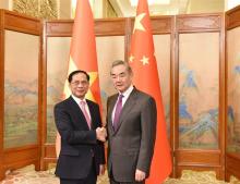 Deputy Prime Minister and Minister of Foreign Affairs Bùi Thanh Sơn (left) shakes hands with Director of the Office of the Communist Party of China Central Committee’s Commission for Foreign Affairs and Minister of Foreign Affairs Wang Yi at the meeting on Tuesday in Beijing. (Photo: VNA)
