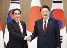 Japanese Prime Minister Fumio Kishida (L) and South Korean President Yoon Suk Yeol shake hands ahead of their talks in Seoul on May 26, 2024. (Pool photo)(Kyodo)