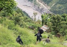 Members of a South Korean government rapid response team travel through Ramche in Rasuwa district, Nepal, on Sept. 2, 2026, to search for the Upper Trishuli-1 (UT-1) hydropower plant site following massive floods that left nine South Koreans unaccounted for. (Yonhap)