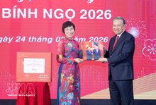 VNA General Director Vu Viet Trang (L) presents a photo book to Party General Secretary To Lam. (Photo: VNA)