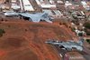 Indonesian Air Force (TNI AU) Chief of Staff Air Marshal Mohamad Tonny Harjono aboard a T-50i fighter jet (right) maneuvers in mid-air alongside Royal Australian Air Force (RAAF) Chief of Air Force Air Marshal Stephen Chappell flying an F/A-18 Hornet (left) over the skies of Darwin, Australia, on Tuesday (August 4, 2026).