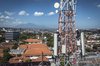 technician performing routine maintenance on an XLSMART 5G Base Transceiver Station (BTS)