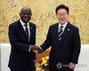 President Lee Jae Myung (R) and International Labour Organization Director-General Gilbert Houngbo shake hands ahead of their meeting at Cheong Wa Dae in Seoul on May 22, 2026. (Yonhap)