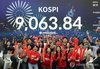 Employees celebrate after the closing bell in a dealing room of Woori Bank in Seoul on June 18, 2026, as the benchmark Korea Composite Stock Price Index surpassed another historic landmark of 9,000 points. (Yonhap)