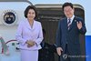 South Korean President Lee Jae Myung (R), alongside his wife, Kim Hea Kyung, waves before flying back home from Frankfurt airport on Aug. 2, 2026, wrapping up a five-nation trip from July 24 that took him to Brazil, Chile and Argentina for talks with their leaders. (Yonhap)