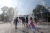 Children and their parents cool off at a water fountain in the southeastern city of Yangsan on Aug. 2, 2026, when the temperature soared to a national record of 42.5 C. (Yonhap)
