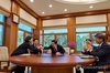 President Lee Jae Myung (C) shakes hands with Lee Hai-min (L), senior presidential secretary for AI policy and future planning, while watching a live broadcast of rocket Nuri's launch from Cheong Wa Dae in Seoul on Oct. 7, 2026, in this photo provided by his office. (PHOTO NOT FOR SALE) (Yonhap)
