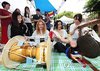 Foreign students try out "pungmullori," a traditional Korean art form that combines music, dance and acrobatics, during a club expo of Ajou University held on the school's campus in Suwon, Gyeonggi Province, in this file photo from Sept. 2, 2026. (Yonhap)